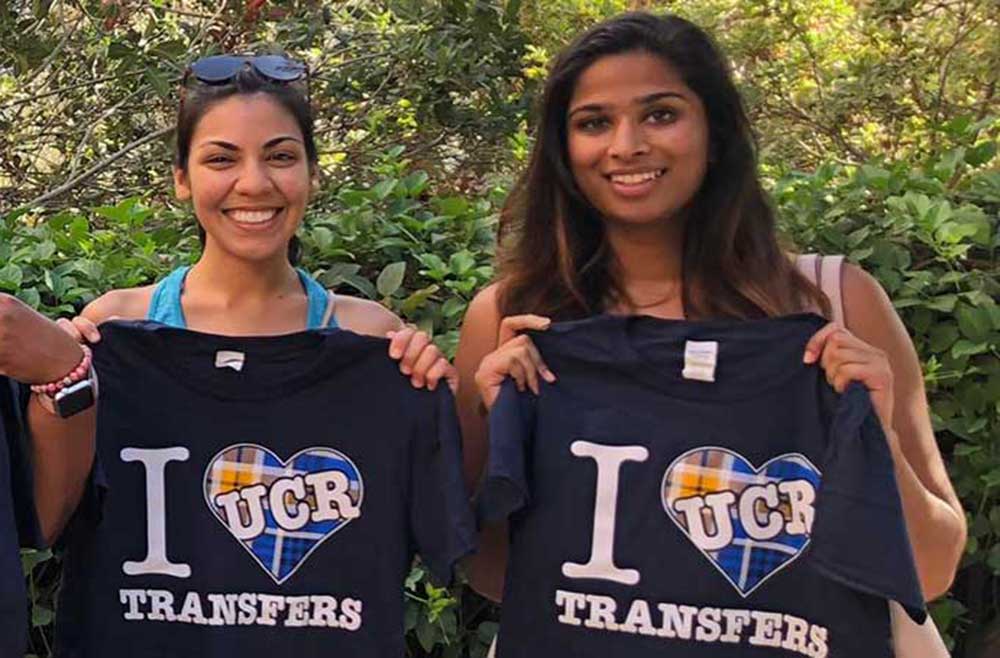 students holding I love UCR Transfer students T-shirts
