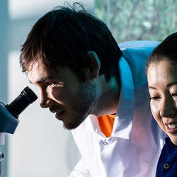 students in the lab with microscope
