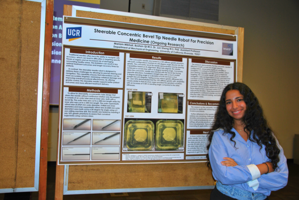 Student poses next to poster at 2024 MSRIP symposium