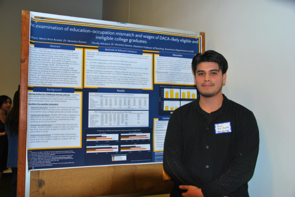 Student poses next to poster at 2024 MSRIP symposium